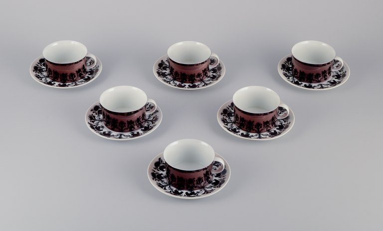 Bjørn Wiinblad for Rosenthal, Germany. A set of six "Berlin Hilton" coffee cups 
with saucers in porcelain. Glossy copper-colored decoration.