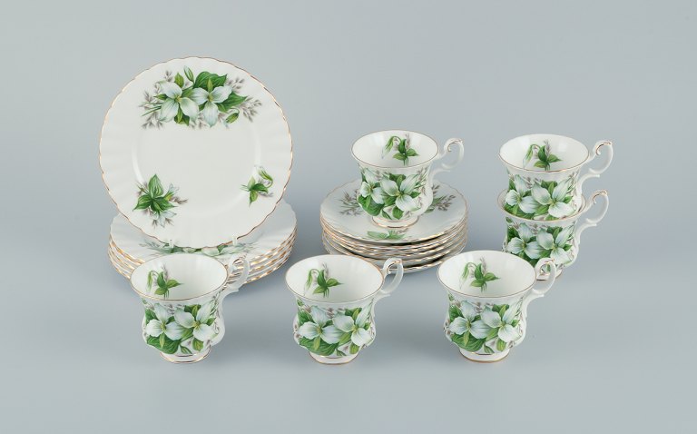 Royal Albert, England. A set of six "Trillium" coffee cups with saucers and cake 
plates. Decorated with flowers and gold trim.