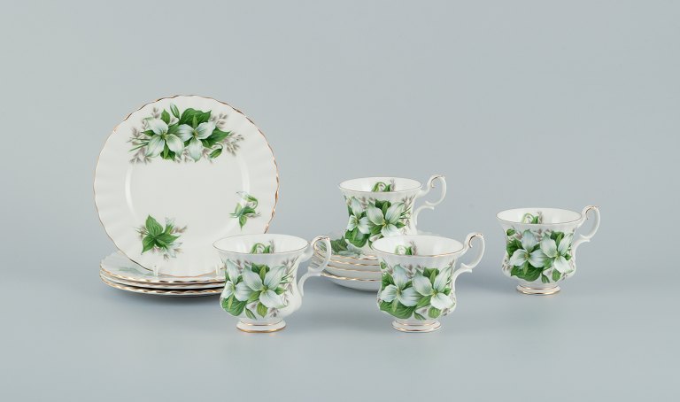 Royal Albert, England. A set of four "Trillium" coffee cups with saucers and 
cake plates. Decorated with flowers and gold trim.