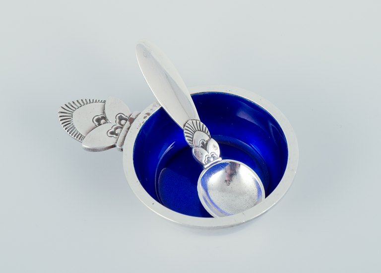 Georg Jensen Cactus. Salt cellar in sterling silver with accompanying salt 
spoon. Interior with royal blue enamel.