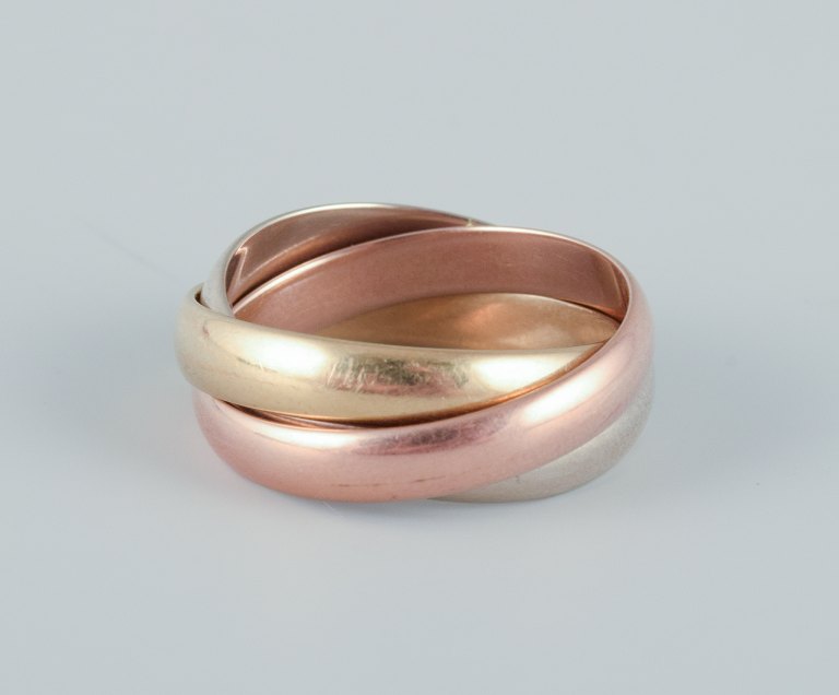 Cartier "Trinity" ring in 18 karat gold, white gold, and rose gold.