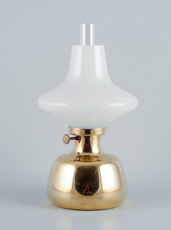 Henning Koppel for Louis Poulsen. Petronella oil lamp in brass with an opal 
glass shade.