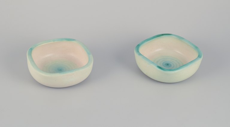 Elchinger, France. Two ceramic bowls with light-toned glaze. Hand-decorated. 
Spiral-shaped decoration.