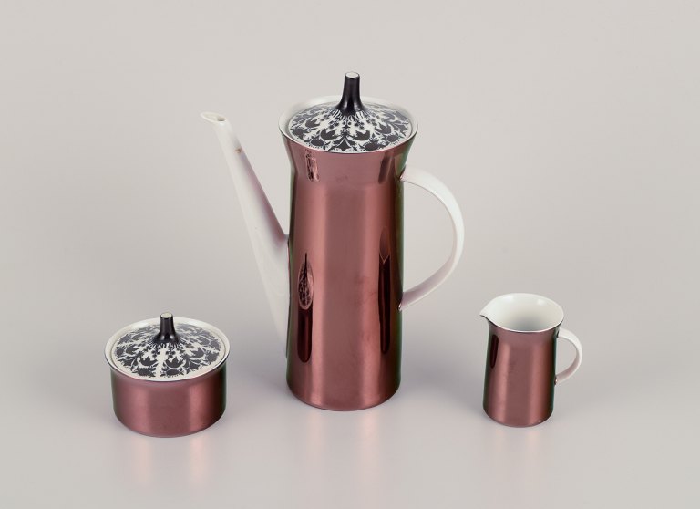 Bjørn Wiinblad (1918-2006) for Rosenthal, Germany. "Berlin Hilton" porcelain 
coffee pot, sugar bowl, and creamer. Glossy copper-colored decoration.