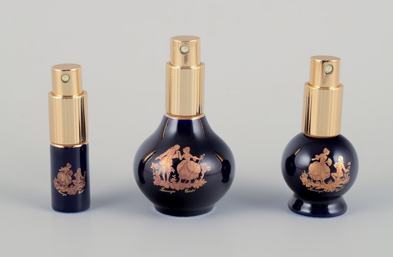 Limoges, France. Three porcelain perfume bottles, decorated with 22-karat gold 
leaf and a beautiful royal blue glaze. Scène galante.