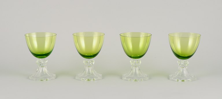 Val St. Lambert, Belgium. A set of four white wine glasses in green and clear 
mouth-blown crystal glass.