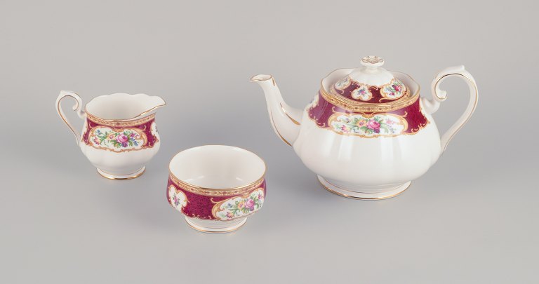 Royal Albert, England. "Lady Hamilton." Large teapot, sugar bowl, and creamer 
with polychrome floral motifs and gold decoration.