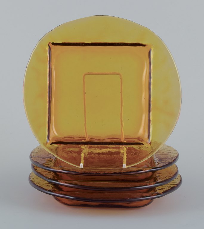 Scandinavian glass designer. A set of four plates in smoke-coloured art glass.