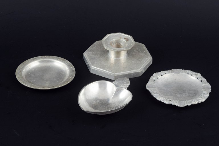 Just Andersen, Denmark.Collection of three small pewter dishes and a candlestick.