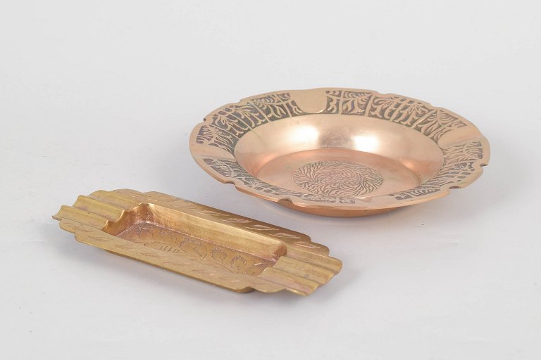 Two brass ashtrays.
