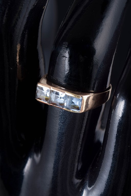 14 carat gold ring with light blue synthetic spinels.