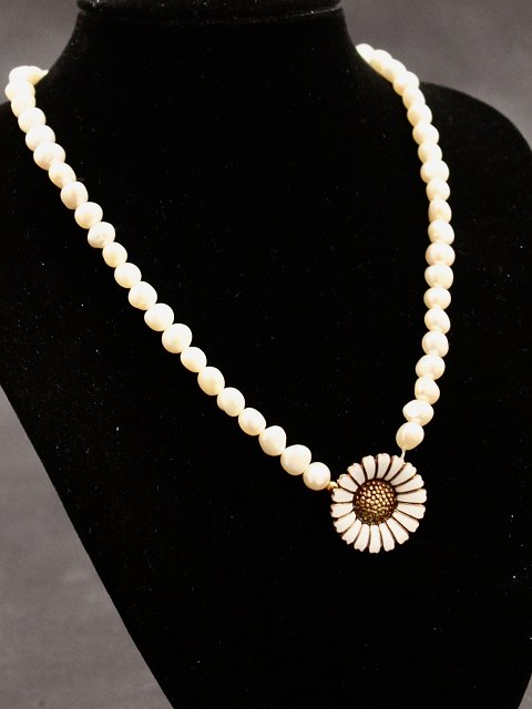 Pearl necklace with A Michelsen daisy brooch