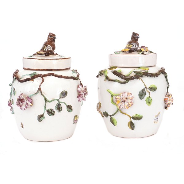 Two polychrome-decorated lidded vases, plastically modelled and decorated with flowers, branches and birds. Marieberg, Sweden, circa 1765. Height: 26 cm