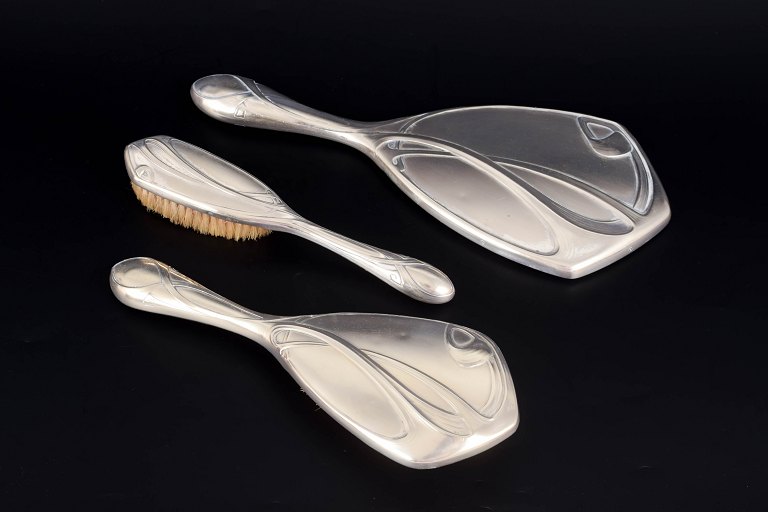 Art Nouveau, set of three silver-plated hairdressing pieces.
